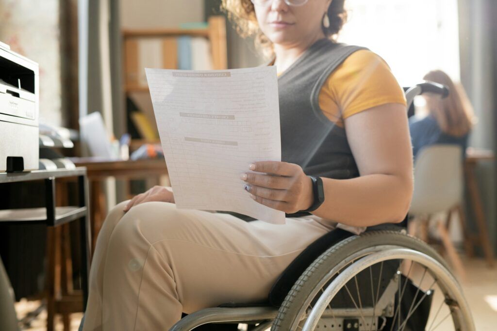 woman in wheelchair reviewing document