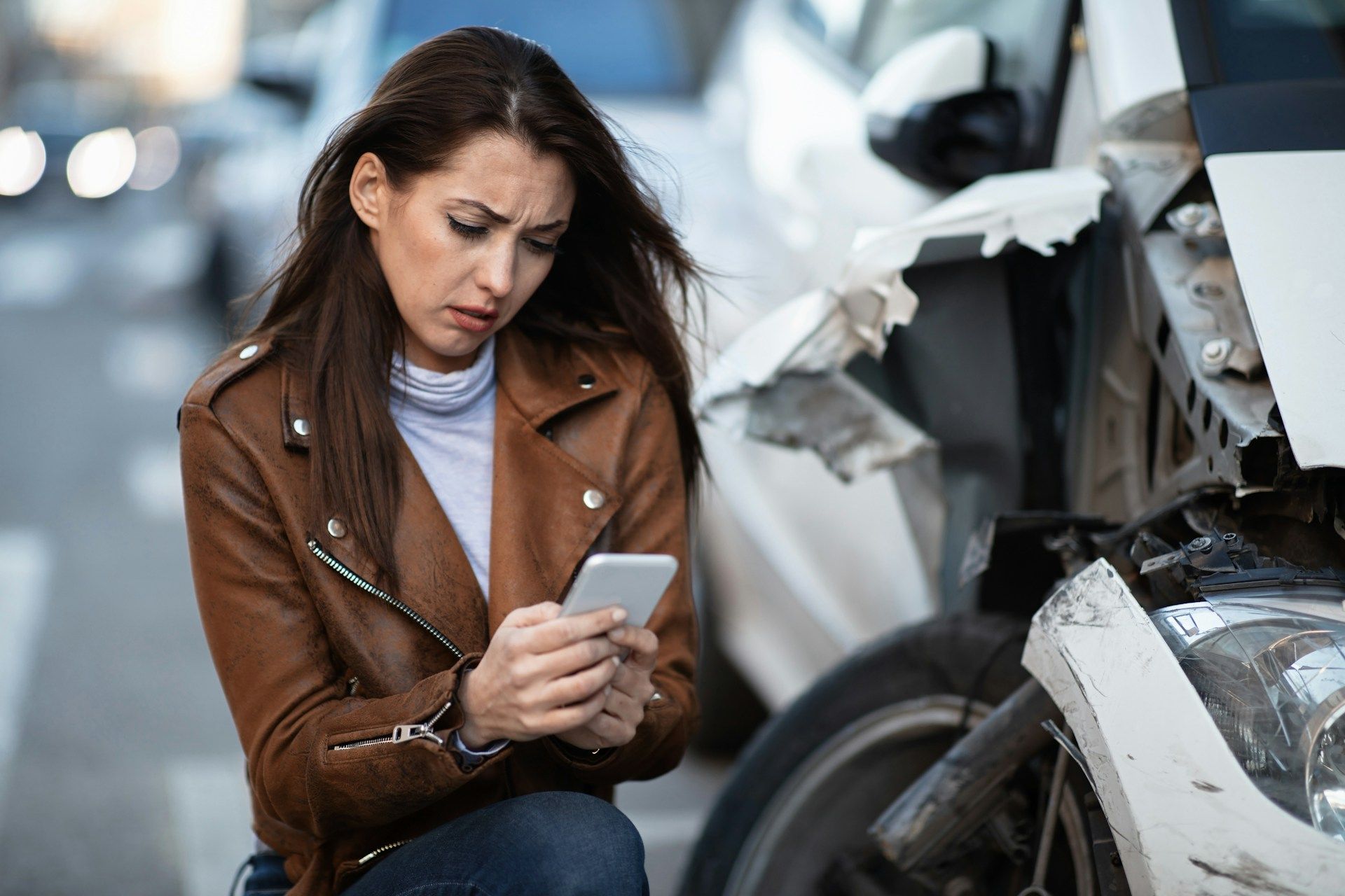 woman next to wrecked car