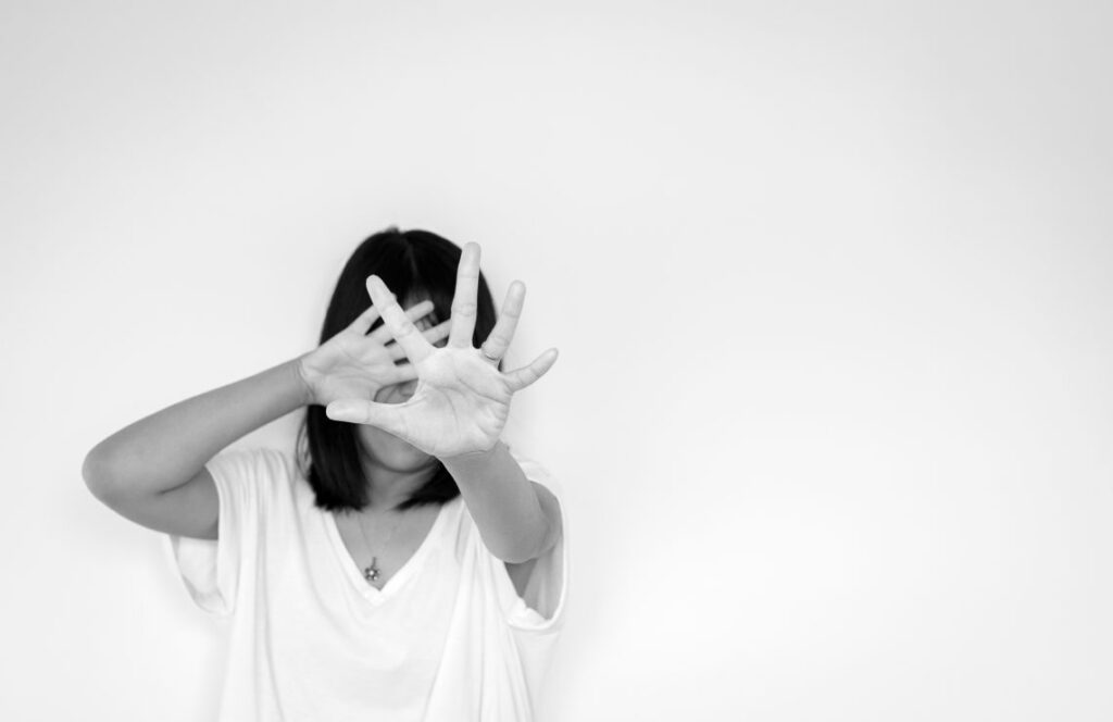 woman covering her face with hands