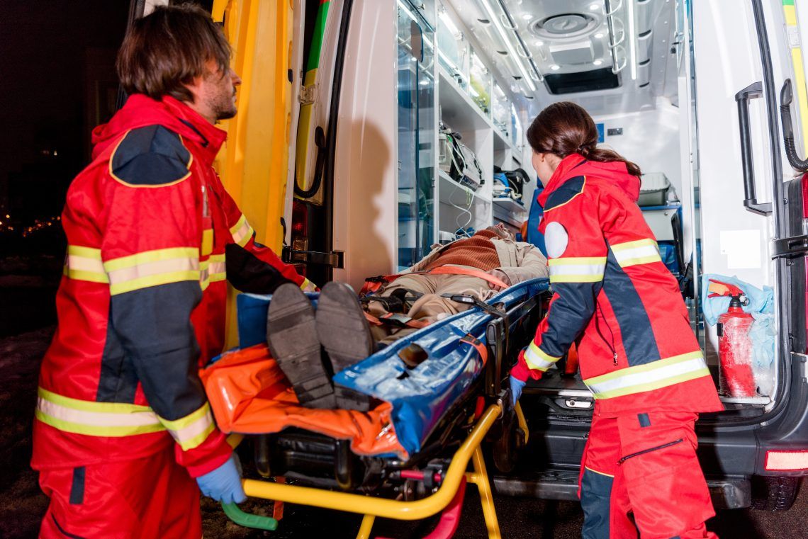 paramedics placing someone inside ambulance